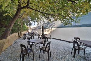 a row of tables and chairs next to a wall at Hotel Frenchcode in Busan