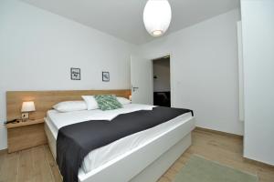 Posteľ alebo postele v izbe v ubytovaní Villa Tećo - Moderne Apartments mit Pool und Meerblick