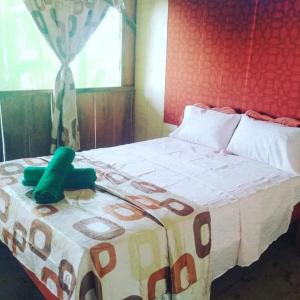 a bedroom with a bed with a phone on it at Amazon Lodge and Expeditions in Iquitos