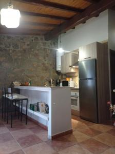 a kitchen with a refrigerator and a table at Casa Rural El Turuterro in Cepeda