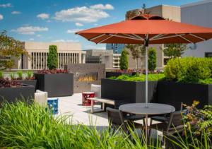 a patio with a table and an umbrella at Fantastic 2BR Condo With Rooftop in Arlington