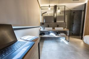 a laptop sitting on a counter in a bathroom at Hotel VIDA Devalar Do Mar in Camariñas