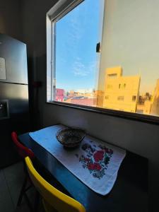 薩爾瓦多的住宿－Apartamento encantador em salvador，窗边的桌子上放着碗