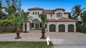 a house with palm trees in front of it at 5000 Square Ft Beautiful Mansion w 6br Hot Tub Playground Movie Theater & Game Room in Dania Beach