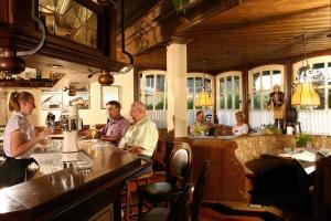 a group of people sitting at a bar in a restaurant at Landhotel Lippischer Hof in Lügde +11 photos