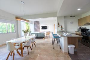 a kitchen and living room with a table and chairs at Cap Cana 3br Full Kitchen, Wifi, Smart Check-in in Punta Cana