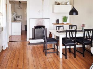 a kitchen with a table and chairs and a fireplace at 6 person holiday home in SÄFFLE-By Traum in Säffle