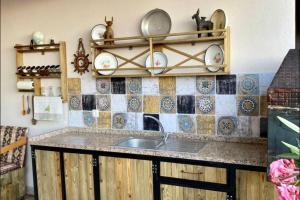 a kitchen with a sink and plates on the wall at Familiar Villae in Capadoccia Turkey in Avanos