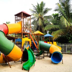 a playground with a bunch of slides in the sand at Pousada Vitoria Aquiraz in Aquiraz