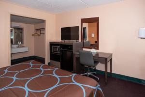 a hotel room with a desk and a bed and a computer at Super 8 by Wyndham Black Mountain in Black Mountain