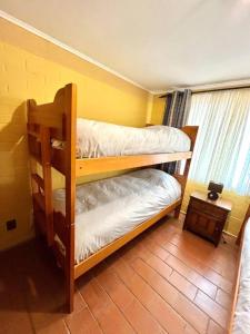 two bunk beds in a room with a window at Cabaña Algarrobo in Algarrobo