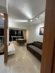 a living room with a couch and a table at Recanto do Bosque FLAT 205 in Caldas Novas