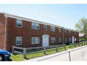 a brick building with a fence in front of it at 17 S First - Unit 6 17 s first street unit 6 in Trenton