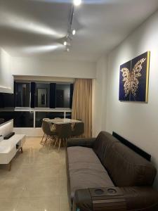 a living room with a couch and a table at Recanto do Bosque FLAT 205 in Caldas Novas
