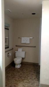 a bathroom with a white toilet in a room at Old Town Inn in San Diego