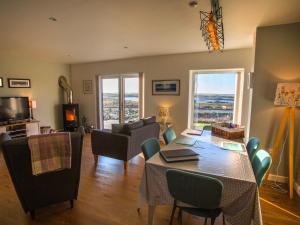 a living room with a table and chairs and a couch at Heatherlea in Carinish