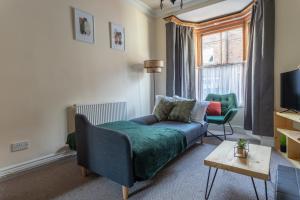 ein Wohnzimmer mit einem Sofa und einem TV in der Unterkunft Milton Stays - Cosy Home in Central York for 6 With On Street Parking in York