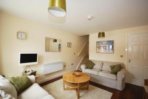 a living room with a couch and a table at House Martins Beadnell in Beadnell