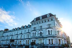 a large white building with a black roof at Chatsworth House Hotel in Llandudno