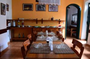 a dining room with a wooden table and chairs at Pousada Nossa Casa in Lençóis