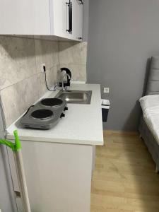 a small kitchen with a sink and a bed at Ti6 in Istanbul