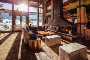 a living room with a fireplace in a lodge at The Inn at Aspen in Aspen