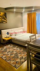 a bedroom with a large bed and a rug at Confort View Apartment Iași - 3 rooms-Like Home in Iaşi