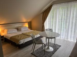 um quarto com uma cama, uma mesa e uma mesa em Apartament Czarna Góra - Resort - Solden - Sienna em Sienna