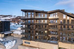 an architectural rendering of a apartment building with snow at Splitter ny leilighet med panoramautsikt in Beitostøl