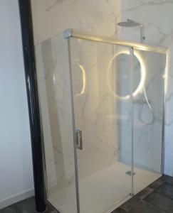 a shower stall with a glass door with two handles at Loft Casa del Agua Ubrique in Ubrique