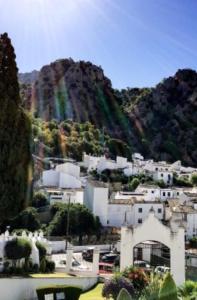 a city with a rainbow on a mountain at Loft Casa del Agua Ubrique in Ubrique