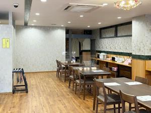 a restaurant with tables and chairs in a room at Hotel Bayside Mihara - Vacation STAY 00520v in Mihara