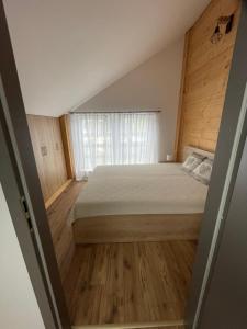 a bedroom with a large bed and a window at U plechového Jánošíka in Terchová