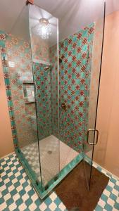 a shower with a glass enclosure in a bathroom at Glamping Hollywood Hills - Luxury Tiny House in Los Angeles