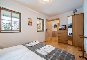 Ένα ή περισσότερα κρεβάτια σε δωμάτιο στο Chalet Alpina