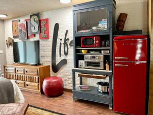 a room with a red refrigerator in a kitchen at Lake Front Studio with Kayaks Bikes near Greenbelt in Boise