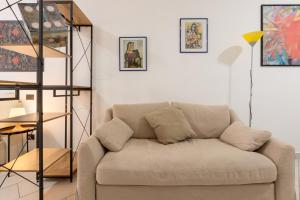 a living room with a couch and paintings on the wall at Locanda del Buongustaio in Cagliari