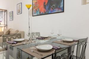 a dining room with a glass table and chairs at Locanda del buongustaio in Cagliari