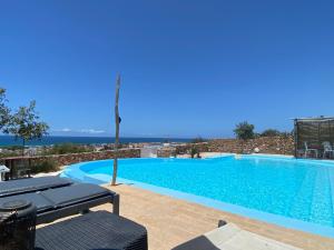 a swimming pool with a view of the ocean at Les oliviers in Oualidia