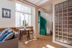 a living room with a couch and a table at Bright designer Loft in the city center in Rīga