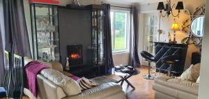 a living room with a couch and a fire place at Rosemount in Sligo