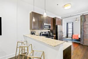 a kitchen with a counter and two stools at West End Gem in Nashville