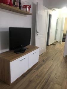 a living room with a flat screen tv on a cabinet at Flat Elbasan city center 4 in Elbasan