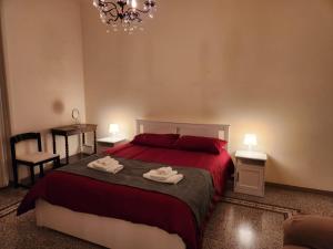a bedroom with a bed with two towels on it at La grande casa di Puglia in Gioia del Colle