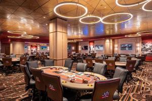 a casino with a poker table and chairs at Horseshoe Las Vegas in Las Vegas