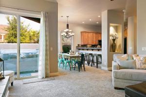 a living room with a couch and a table with chairs at Lava Falls #9 townhouse in Santa Clara