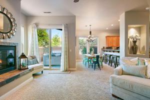 a living room with a fireplace and a dining room at Lava Falls #9 townhouse in Santa Clara