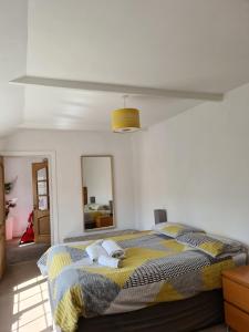 a bedroom with a bed with two stuffed animals on it at Resthaven Cottage in Mablethorpe