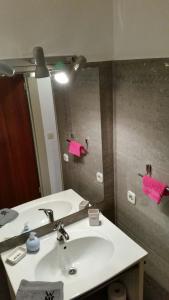 a bathroom with a white sink and a mirror at Green House Strassen in Strassen