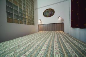 a bedroom with a bed with a quilt on it at Judy and Sandor Apartmen in Budapest